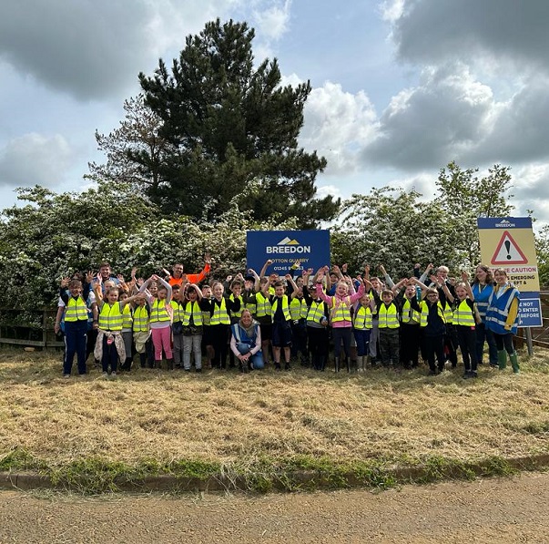 Glamis and Eassie primary school's visit tot Breedon Aggregates Powmyre Quarry a Roundyhill, Glaimis.

Pic shows Chief Executive Alan MacKenzie- Regional Director, East Brad Murphy helping youngsters planting some wild flower seeds in specially dug beds
Pic Paul Reid
